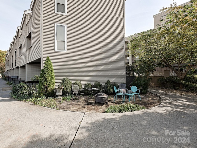 view of home's exterior with a fire pit