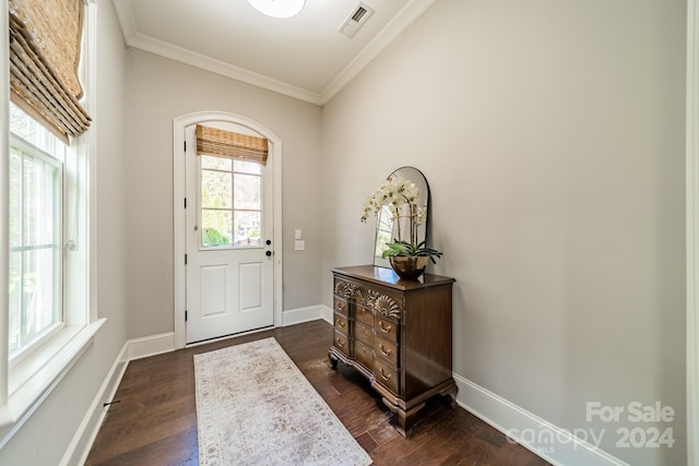 doorway featuring dark wood-type flooring and crown molding