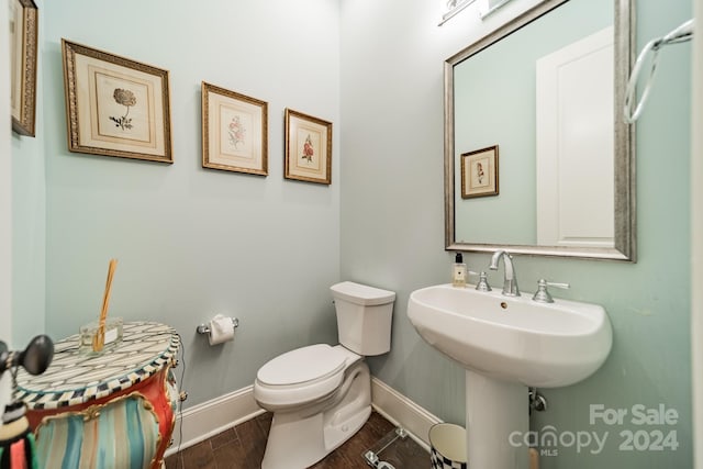 bathroom with wood-type flooring and toilet