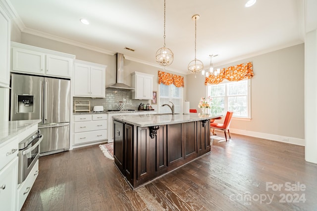 kitchen featuring white cabinetry, wall chimney exhaust hood, stainless steel appliances, dark hardwood / wood-style floors, and an island with sink