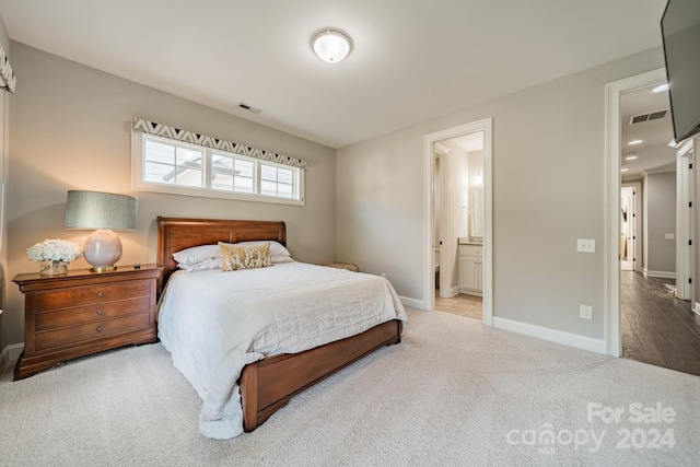 carpeted bedroom with ensuite bath