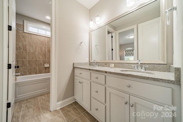 bathroom featuring vanity and tiled shower / bath