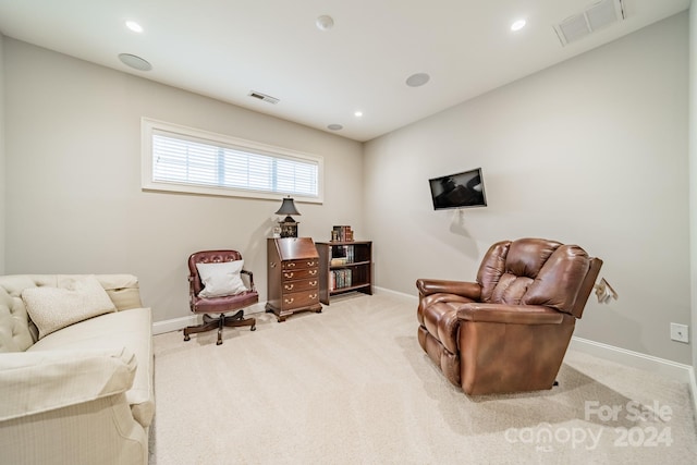 sitting room featuring light carpet