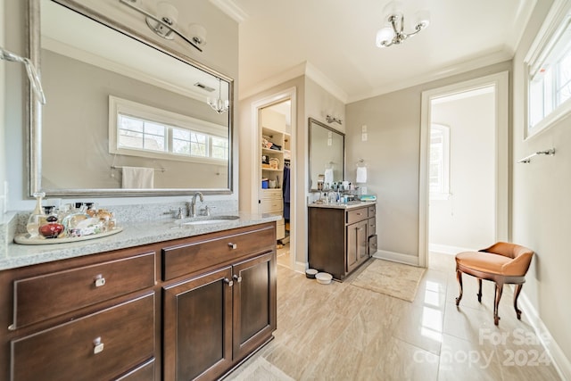 bathroom with vanity and ornamental molding