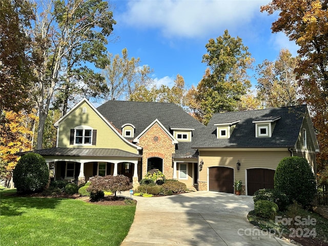 view of front of house with a front yard and covered porch