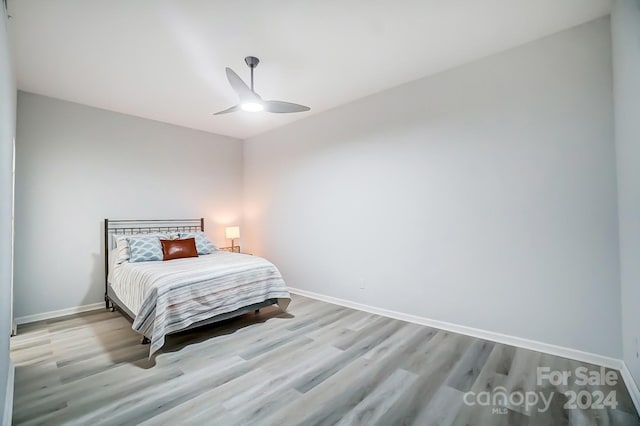 bedroom with light hardwood / wood-style floors and ceiling fan