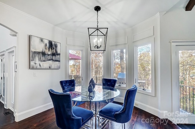 dining space with an inviting chandelier, crown molding, and dark wood-type flooring