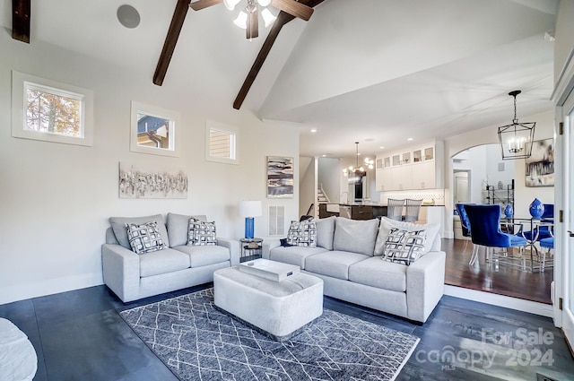 living room with beamed ceiling, dark hardwood / wood-style flooring, high vaulted ceiling, and ceiling fan with notable chandelier