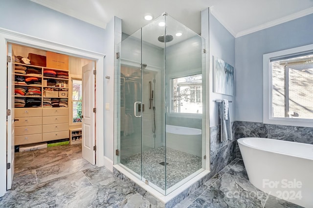 bathroom featuring a wealth of natural light, independent shower and bath, and ornamental molding