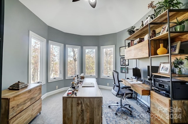 carpeted office space with ceiling fan