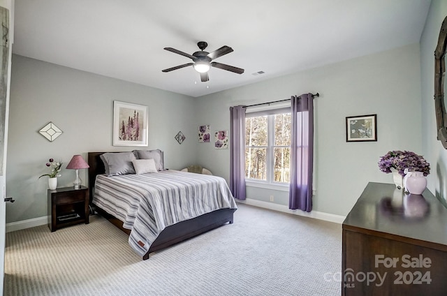 bedroom with light carpet and ceiling fan