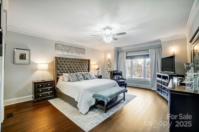 bedroom featuring baseboards, visible vents, a ceiling fan, hardwood / wood-style floors, and ornamental molding