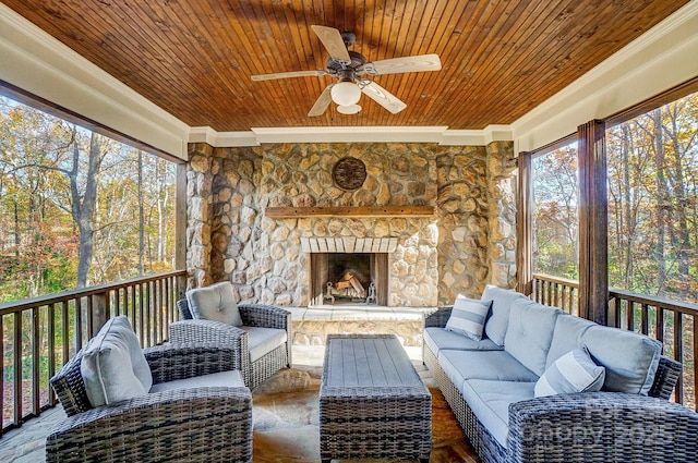 sunroom / solarium with an outdoor living space with a fireplace and ceiling fan
