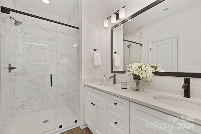 bathroom with vanity, wood-type flooring, and walk in shower