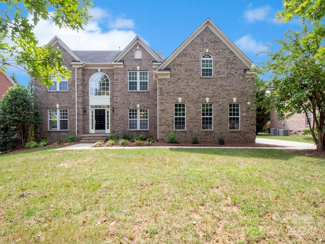 view of front of home with a front lawn and central AC unit