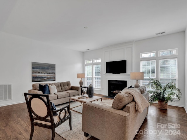 living room with dark hardwood / wood-style flooring