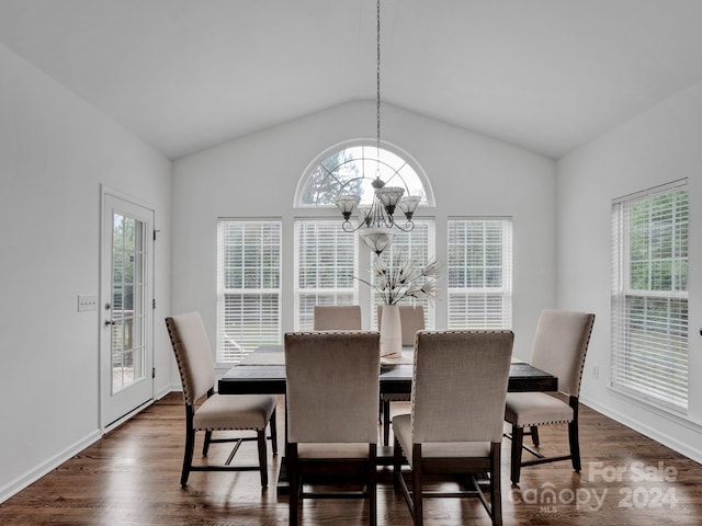 dining room featuring an inviting chandelier, vaulted ceiling, and dark hardwood / wood-style floors