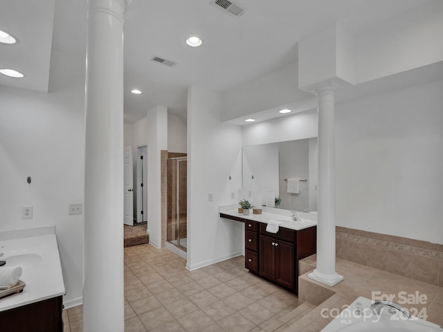 bathroom featuring tile patterned flooring, vanity, ornate columns, and plus walk in shower