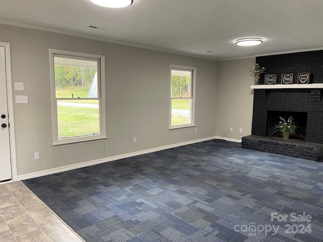 unfurnished living room with crown molding, a fireplace, carpet, and a healthy amount of sunlight