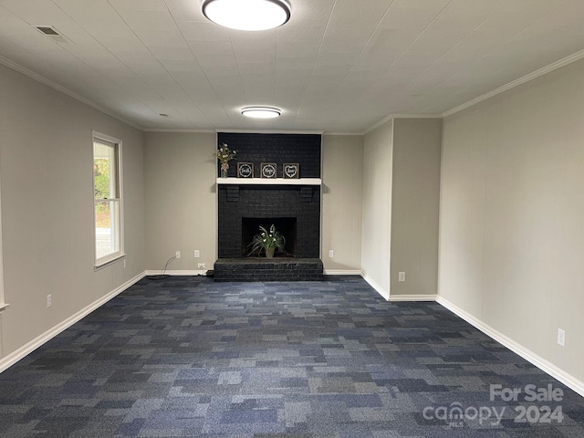 unfurnished living room featuring a fireplace, dark colored carpet, and ornamental molding