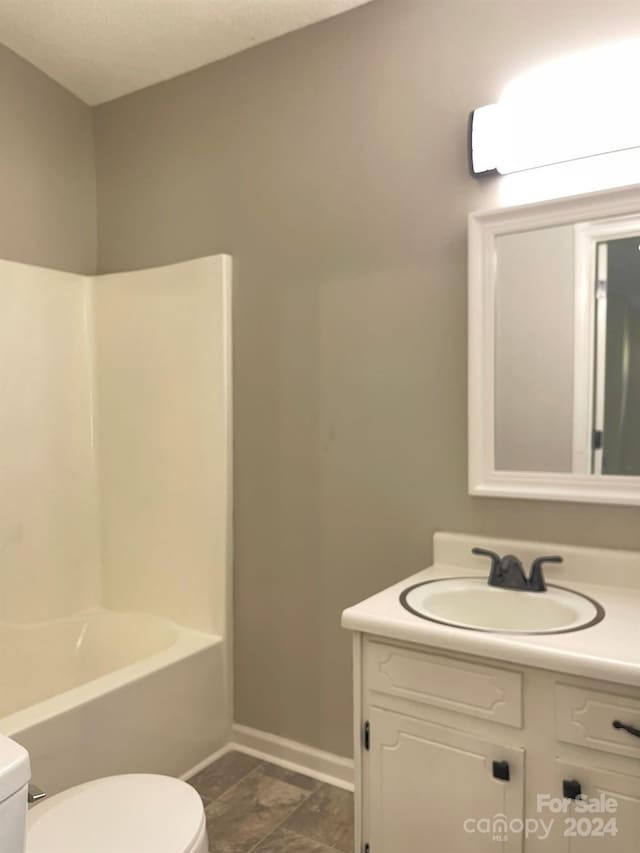 full bathroom with vanity, bathing tub / shower combination, and toilet