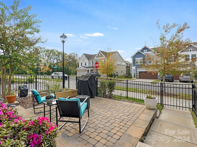 view of patio / terrace with a garage and area for grilling