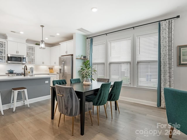 dining space with light wood-type flooring