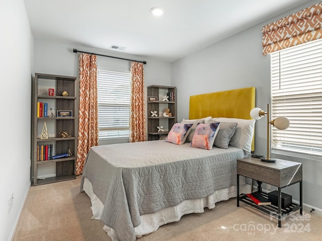 bedroom with light colored carpet