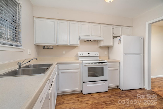 kitchen featuring hardwood / wood-style flooring, sink, white appliances, and white cabinets