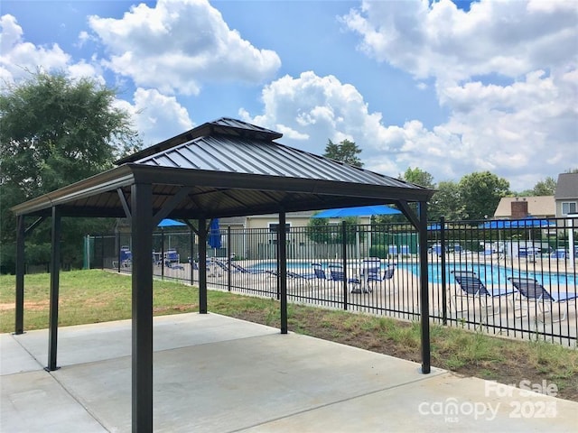 exterior space featuring a pool and a gazebo