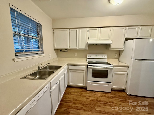 kitchen featuring white cabinetry, sink, and white appliances