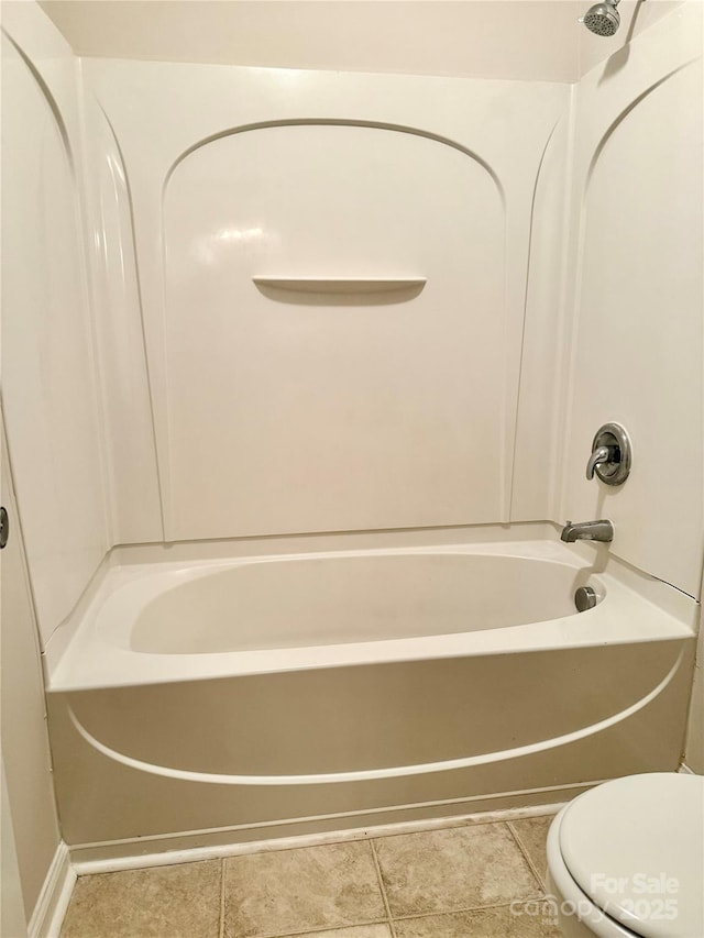 bathroom featuring tile patterned floors, toilet, and shower / washtub combination