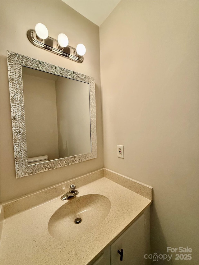 bathroom with toilet and vanity