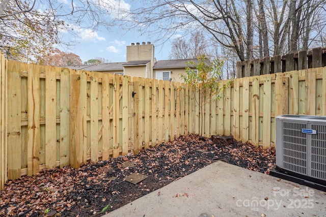 view of yard with central AC and a patio area