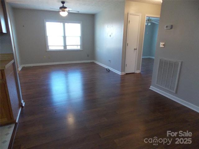 unfurnished room with dark hardwood / wood-style flooring