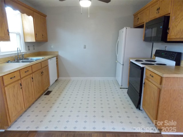 kitchen with white appliances, ceiling fan, and sink