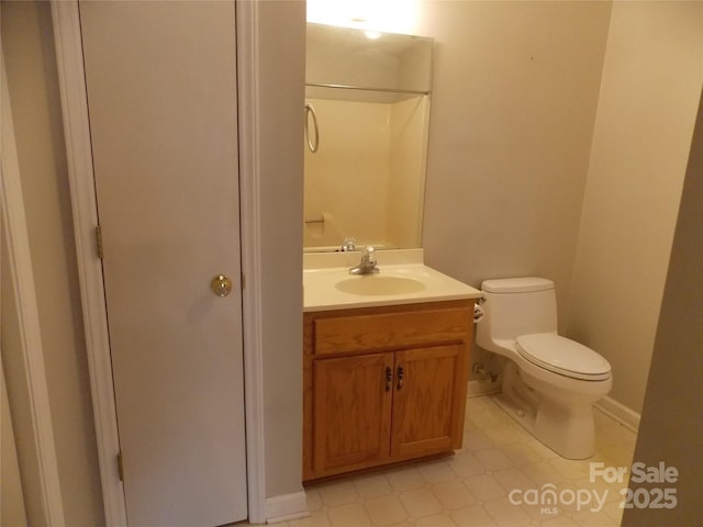 bathroom featuring tile patterned floors, vanity, and toilet