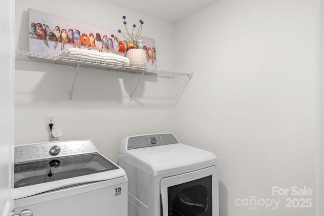 clothes washing area with washing machine and dryer