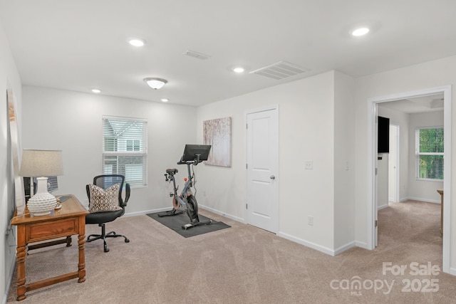 exercise room with light colored carpet