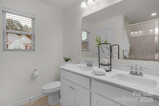 bathroom with a tile shower, tile patterned flooring, vanity, and toilet