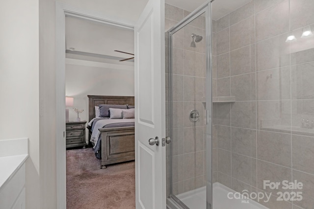 bathroom featuring an enclosed shower and ceiling fan