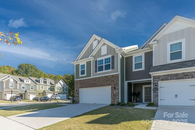 multi unit property with a front lawn and a garage