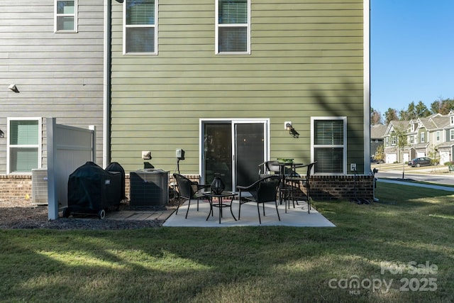 back of property featuring a patio area, a yard, and cooling unit