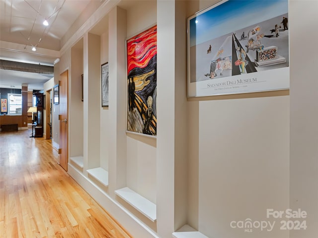 hallway with hardwood / wood-style floors