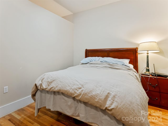 bedroom with hardwood / wood-style flooring