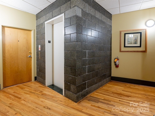 32 Broadway St Unit 230, Asheville, NC 28801 - foyer with elevator, tile walls, and wood finished floors