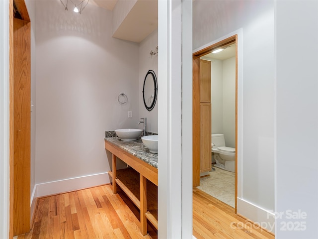 32 Broadway St Unit 230, Asheville, NC 28801 - full bathroom with a sink, baseboards, toilet, and wood finished floors