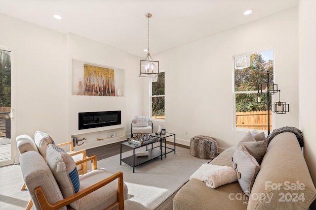 living room with a notable chandelier and light hardwood / wood-style flooring