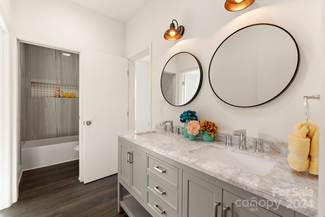 full bathroom with hardwood / wood-style flooring, vanity, toilet, and bathing tub / shower combination