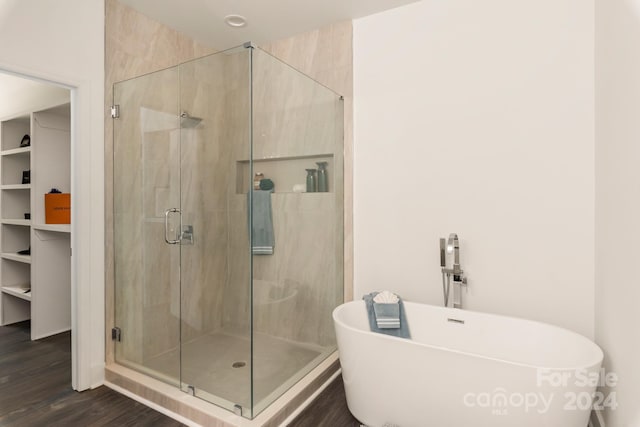 bathroom with hardwood / wood-style flooring and plus walk in shower